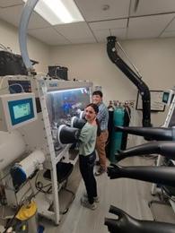 Students using a machine in the lab 