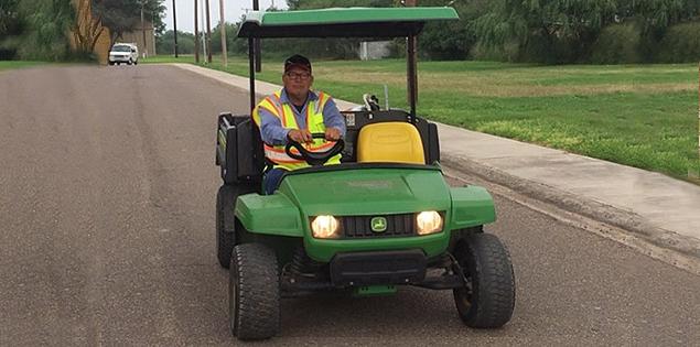 赌博平台 employee driving a utility vehicle.