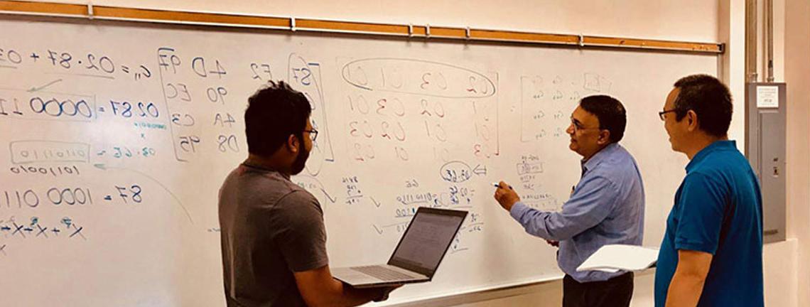 Dr. Kumar and group by whiteboard