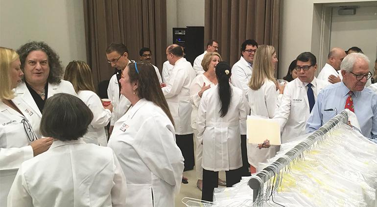 赌博平台 医学院 faculty wearing white coats during faculty assembly event