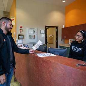 front desk staff helping student